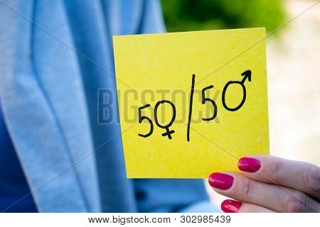 Gender Definition  Concept, A Piece Of Paper With A Female And A Male Symbol In A Woman's Hand
