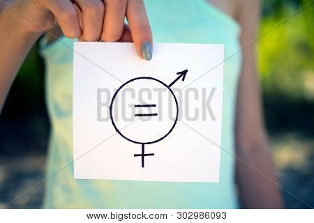 Gender Definition Concept, A Piece Of Paper With A Female And A Male Symbol In A Woman's Hand