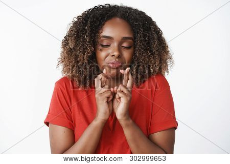 Waist-up Shot Of Funny And Emotive Hopeful African-american Woman Eager To Get New Car Cross Fingers