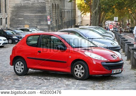 Versailles, France - September 15, 2019: Red Compact Car Peugeot 206+ In The City Street.