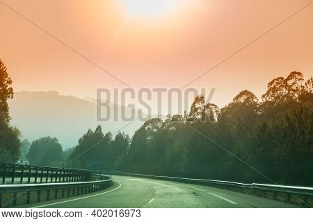 View Of Beautiful Mountain Landscape Through The Windscreen On A Sunny Day. Driving A Car On Mountai