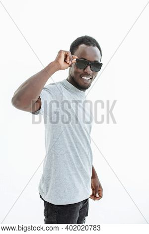 Handsome Guy Looking Intently Through Sunglasses . Isolated On White