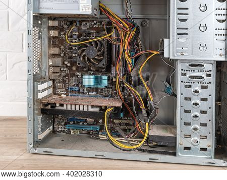 Varna, Bulgaria, December 19, 2020. Inside Of Open Old Dusty Pc System Unit Before Cleaning On A Des