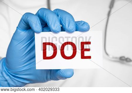 Doctor Holding A Card With Text Doe Dyspnea On Exertion, Medical Concept