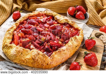 Galette With Strawberry And Rhubarb. Homemade Tart, Tarte. White Wooden Background. Top View