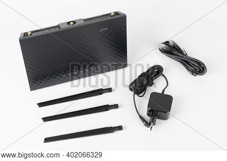 Gigabit Dual-band Wi-fi Router, Power Cable, Network Cable, Three Antennas. Wireless Device On White
