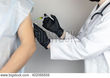 Infectious Disease Doctor Gives The Patient A Medical Vaccination In The Shoulder. Immunization Agai