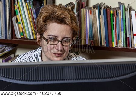 Portrait Of A Busy Woman Telecommuting At Her Desk At The Home. Working At Home Became An Important 