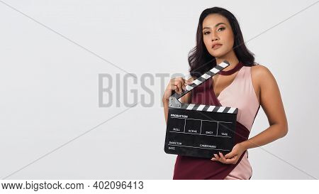 Beautiful Asian Woman With Tan Skin And Hand\'s Holding Clapper Board Or Movie Slate Use In Video Pr