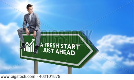 A Fresh Start Green Road Sign Against Clouds And Sunburst.