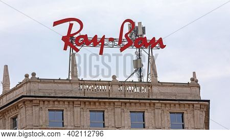 Milan, Italy - June 15, 2019: Big Red Ray Ban Sign At Top Of Building In Milan, Italy.