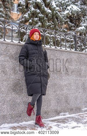 Teen Girl Wearing Casual Clothes Walking On Snow Covered City Street In Winter. Young Lady Spending 