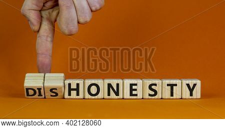 Honesty Or Dishonesty Symbol. Businessman Hand Turns A Cube And Changes The Word 'dishonesty' To 'ho