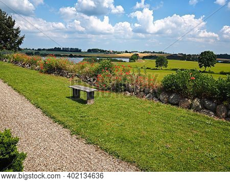 Beautiful Summer Danish Countryside Landscape Over Rolling Hills With Green Fields With Great Clouds
