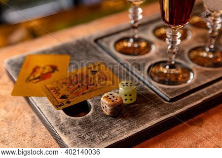 Gambling Concept With Booze, On Bar Table With Cards And Dice