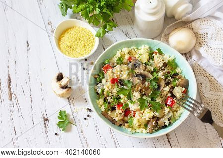 Healthy Diet Food. Vegan Salad With Couscous And Champignons On A Wooden Kitchen Table.