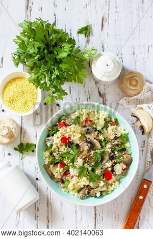 Healthy Diet Food. Vegan Salad With Couscous And Champignons On A Wooden Kitchen Table. Top View Fla