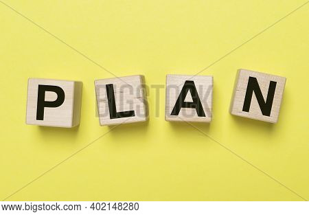 Planword On Wooden Dices Over Yellow Background