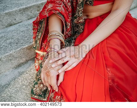 Young Beautiful Indian Woman Walks On Ancient Architecture Streets Of City Of India Dressed In Red S