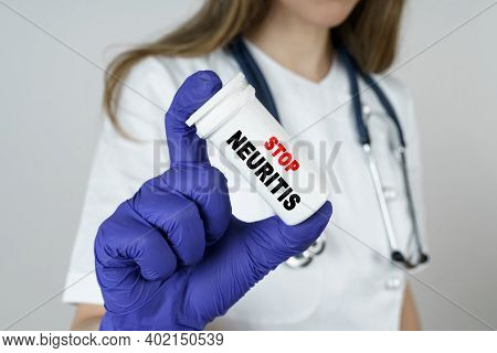 Medicine And Health Concept. The Doctor Holds A Medicine In His Hands, Which Says - Stop Neuritis