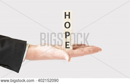 Business Concept., Hand Hold Wooden Cubes With Hope On White Background With Copy Space For Text.