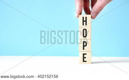 Hope New Year Wooden Cubes On Blue Table Background With Copy Space For Text. Business Goals, Missio