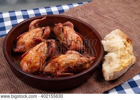 Roasted Quail And Chunk Of White Bread. Rustic Style.