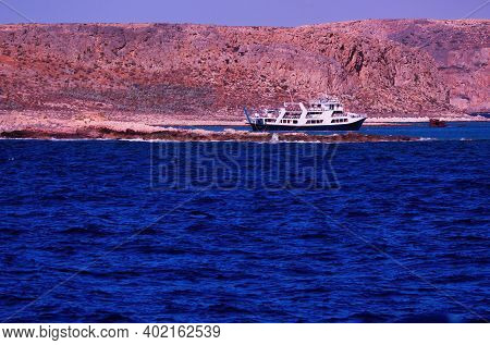 Crete Or Kreta, Greece - September 15, 2017: Blue Mediterranean Sea Water Against Ship Cruise Docked