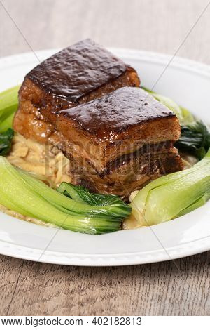Dong Po Pork Meat In A White Plate With Vegetable On Wooden Background.