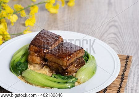 Dong Po Pork Meat In A White Plate With Vegetable On Wooden Background.