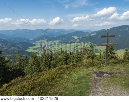 Wooden Double Cross With View On Village Liptovska Luzna At Ridge Of Low Tatras Mountains With Mount