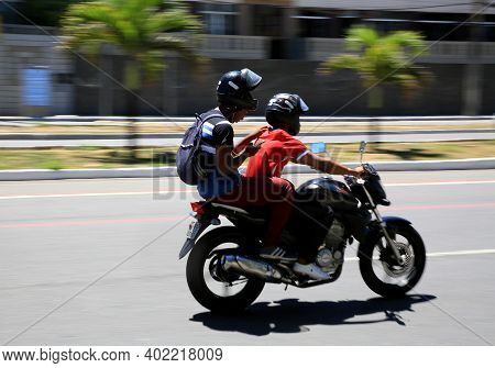 Motorcyclist Is Seen Walking Down The Street