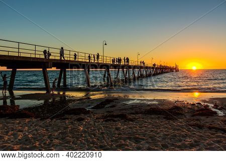 Adelaide, South Australia - March 18, 2017: Crowds Of People Walking Along Glenelg Beach Jetty At Su
