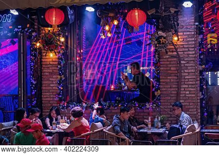 Night Bar With People. Night Life At Famous Tourist Walking Street Bui Vien During Lockdown.  Defocu