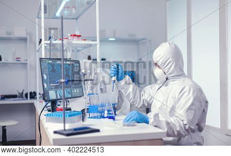 Lab Scientist Uses Micropipette While Examining Sample Doing Drug Development. Chemist In Modern Lab