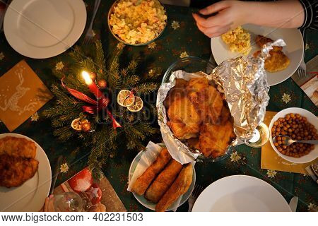 Tabletop Photo Of Traditional Typical Czech Christmas Dinner With Candles And Fish Meat Called Rizek