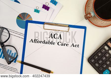 Paper With Aca Affordable Care Act On The Office Table, Calculator And Glasses