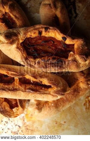 Twisted Pastry Stuffed With Cabbage On The Table. Russian Open Pirozhki, Baked Patties Stuffed With 