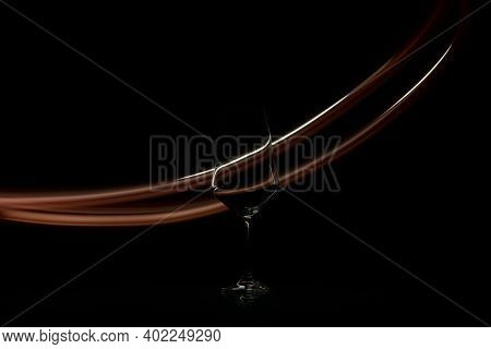 Photo Of Empty Wine Glass With Light Painting Background. It's Only Single Color And It Was Made Wit