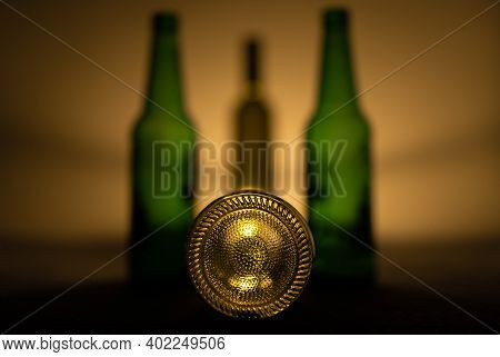 Four Empty Bottles Of Alcohol Drinks In Still Life Photo With Shadows.