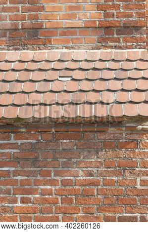 Old Red Brick Wall And Earthen Roof Awning. Selective Focus.