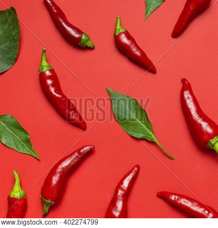Chili Peppers Background. Hot Red And Green Fresh Chili Peppers On Red Background Flat Lay Top View.