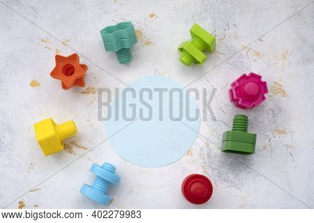 Educational Constructor For Children, Nuts And Bolts In The Form Of Geometric Shapes. Mock Up Backgr
