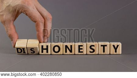 Honesty Or Dishonesty Symbol. Businessman Hand Turns Cubes And Changes The Word 'dishonesty' To 'hon