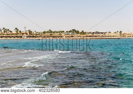 Hurghada, Egypt - September 29 2020: People Relaxing On The Beach In Hurghada, Egypt.