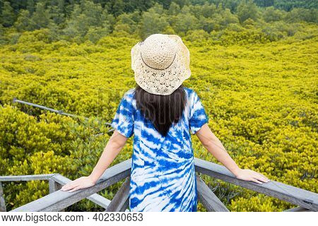 Asian Traveler Woman Holding The Hat And Standing On Wooden Bridge For Travel At Tung Prong Thong Fo