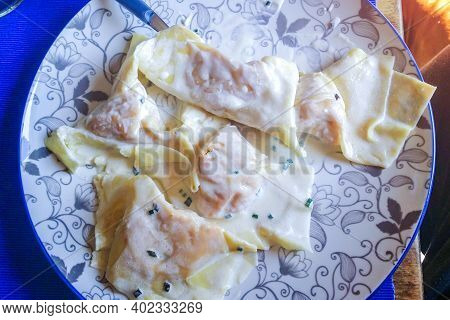 Italian Housewife With Traditional Manual Sheeter Rolls Egg Pasta, The Color Of The Sun Of Italy, Ma