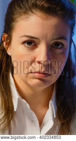 Close Up Of Overworked Business Woman Looking Exhausted At Camera Sighing Working Late At Night In S