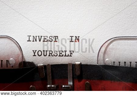 Invest in yourself phrase written with a typewriter.