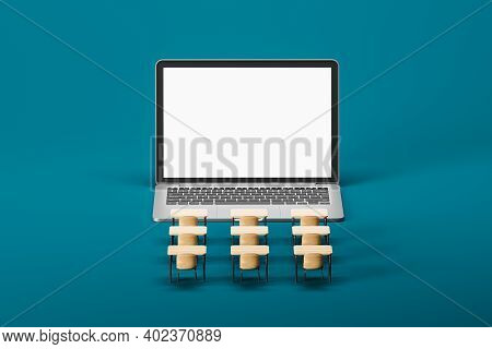 Front View Of Laptop With Mock Up Screeen And Row Of Desks Over Blue Background. Online Education Co